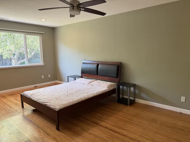 a bedroom with a bed and window