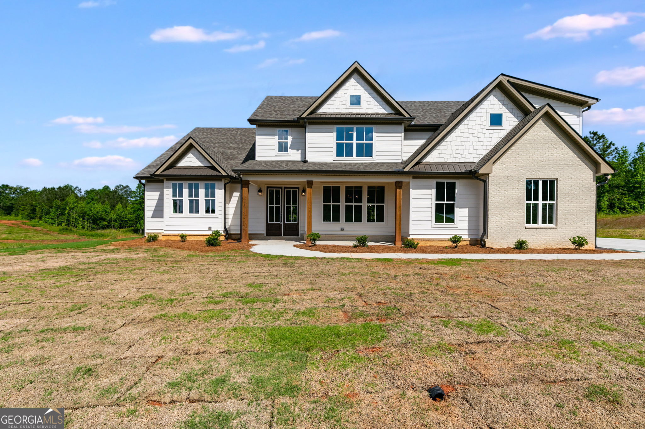 a front view of a house with swimming pool and porch