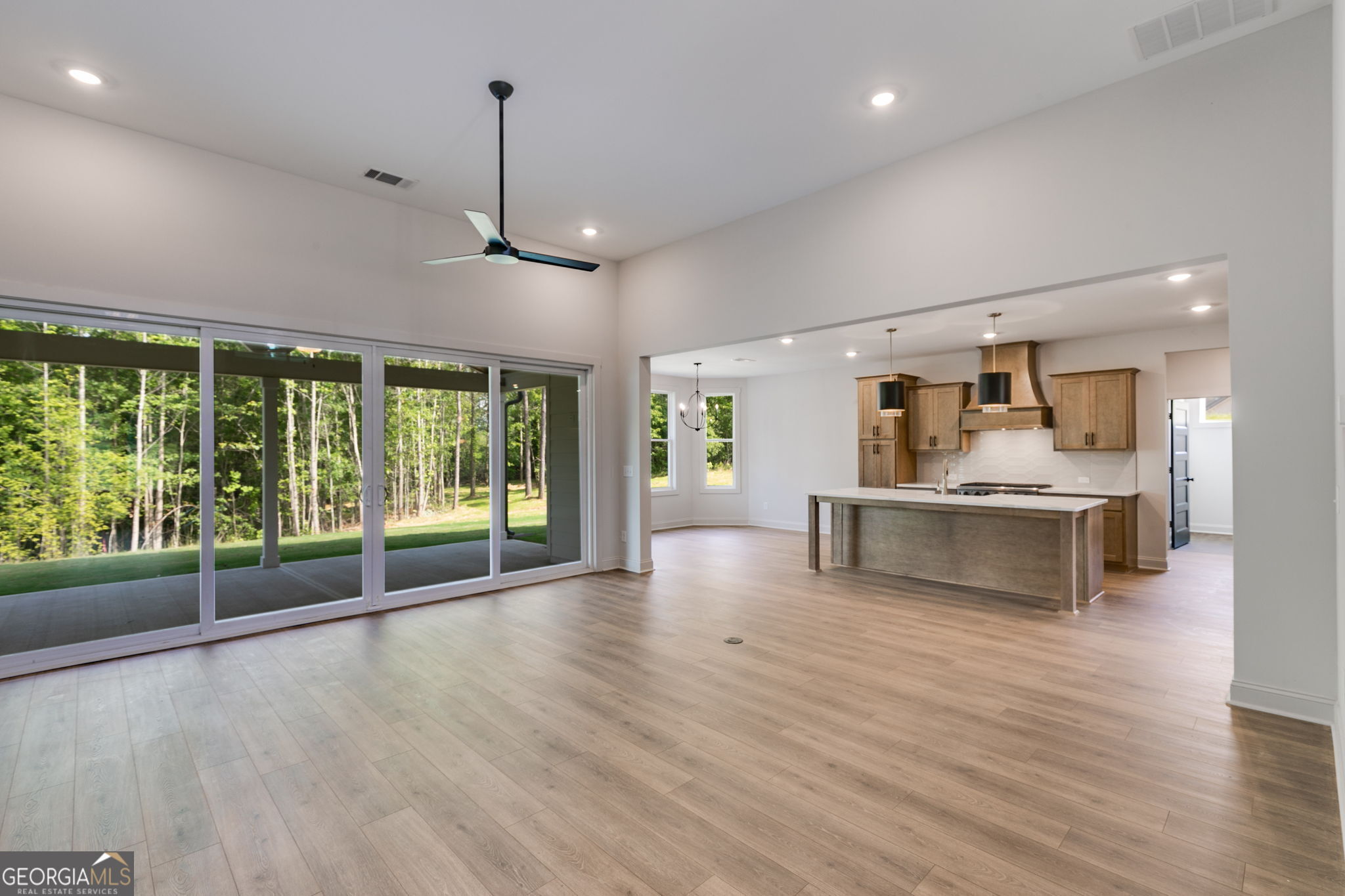 1593 Bethesda Church Road Carrollton, GA 30117 - Photo 12 of 50 a view of an empty room with wooden floor and a window