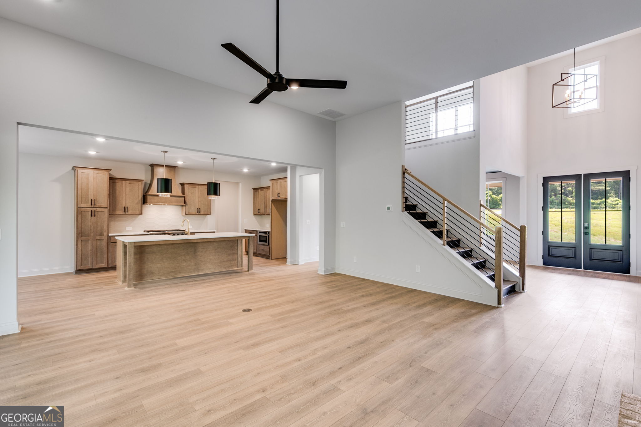 1593 Bethesda Church Road Carrollton, GA 30117 - Photo 16 of 50 a view of a living room and kitchen with furniture wooden floor