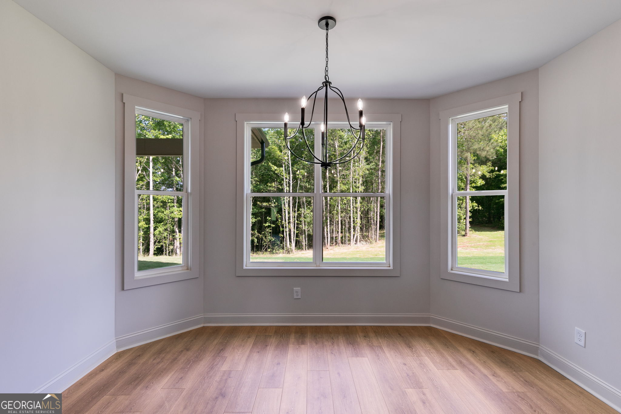 1593 Bethesda Church Road Carrollton, GA 30117 - Photo 19 of 50 a view of an empty room with wooden floor and a window
