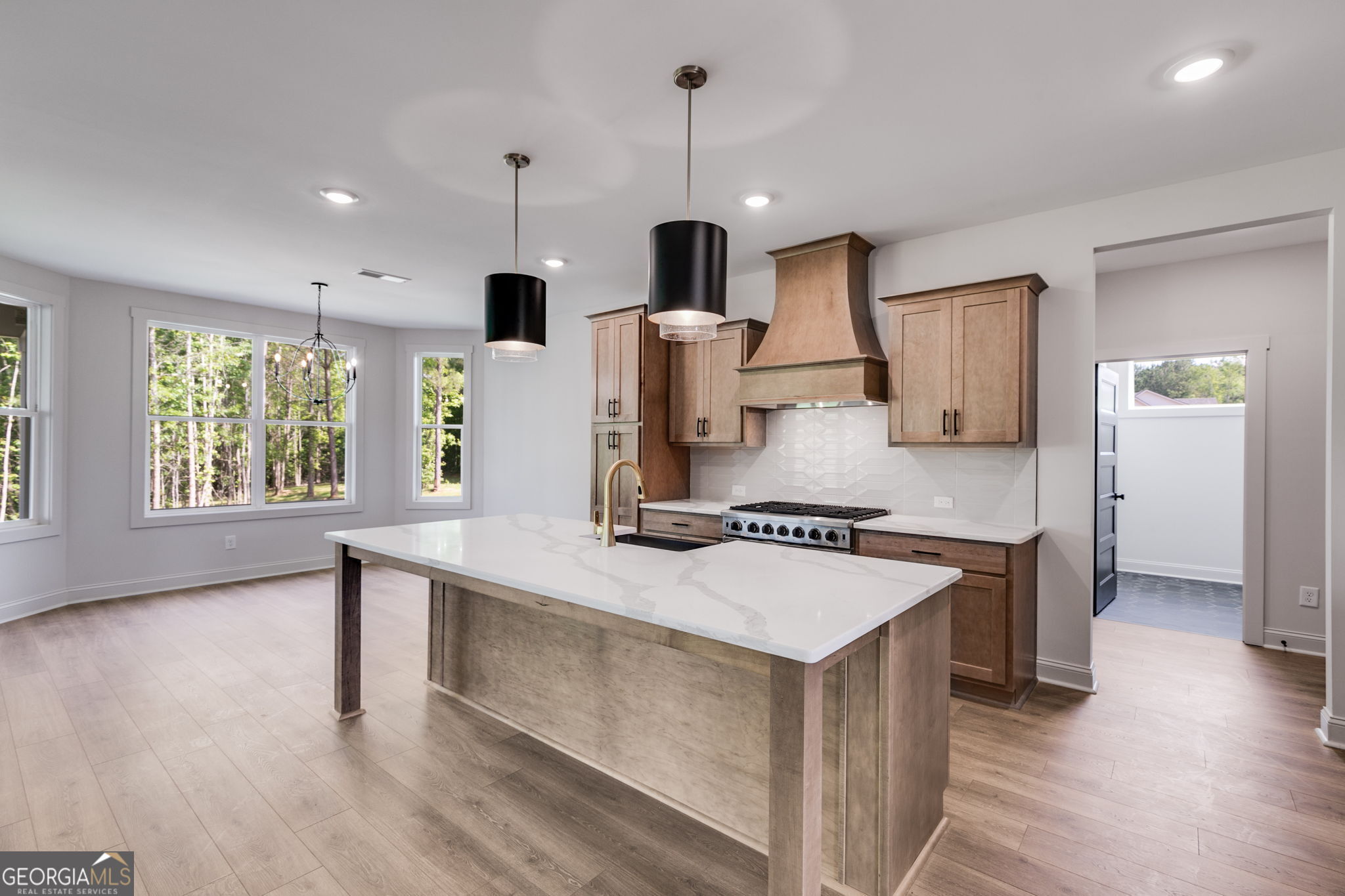 1593 Bethesda Church Road Carrollton, GA 30117 - Photo 26 of 50 a kitchen with a stove and a wooden floors