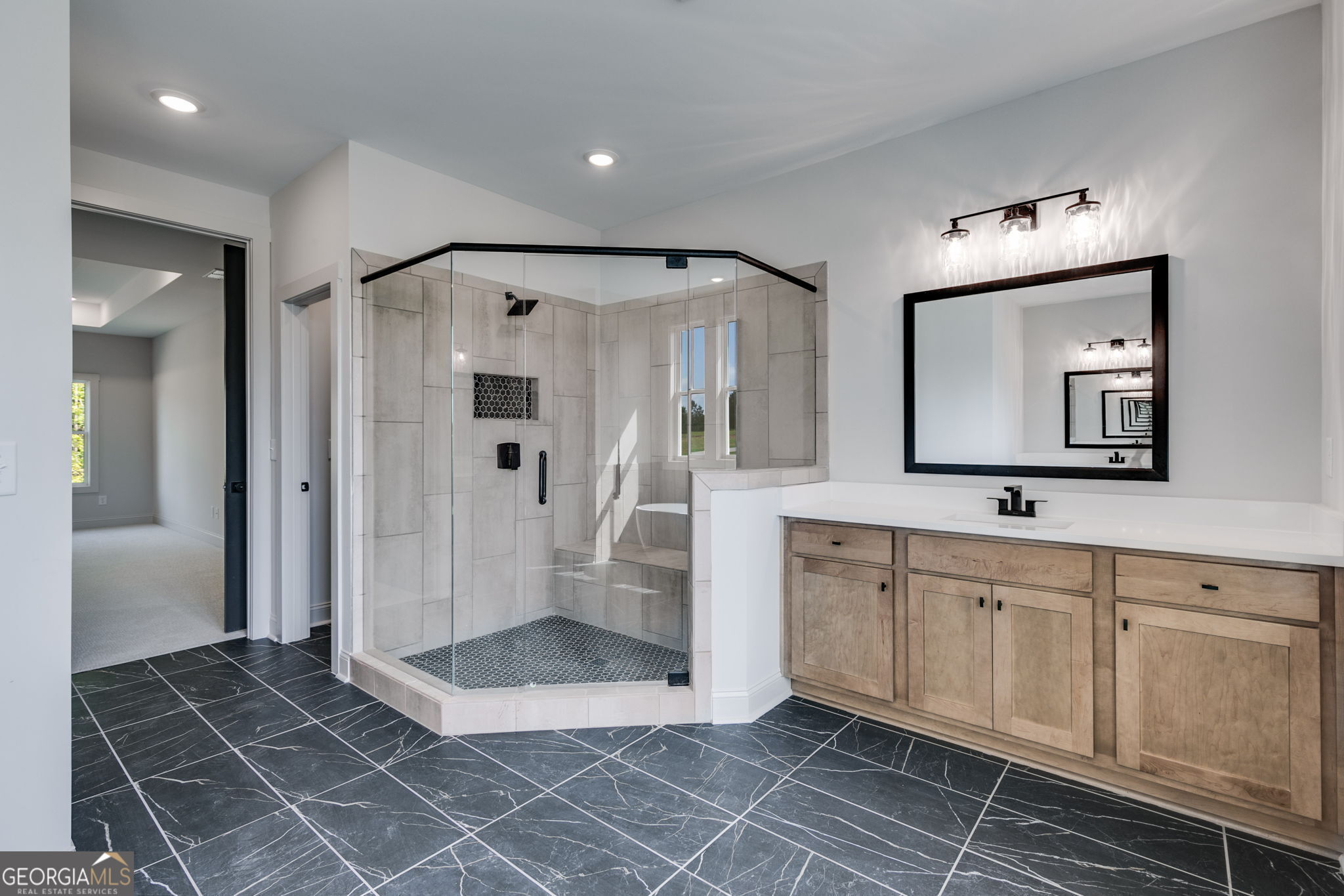 1593 Bethesda Church Road Carrollton, GA 30117 - Photo 37 of 50 a bathroom with a double vanity sink a mirror and a shower