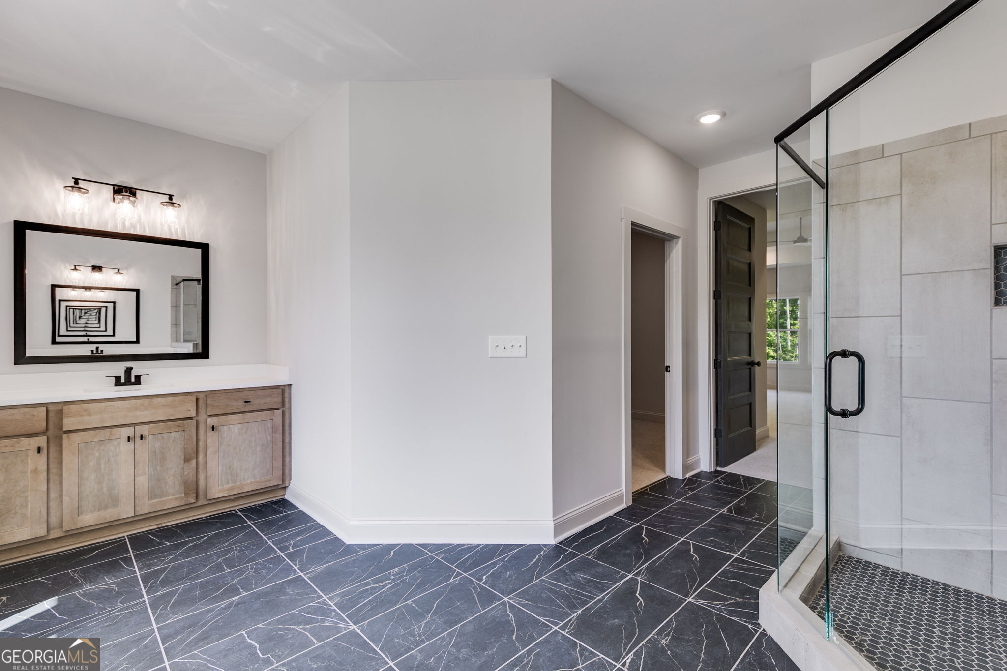 1593 Bethesda Church Road Carrollton, GA 30117 - Photo 38 of 50 a spacious bathroom with a mirror a sink and a shower