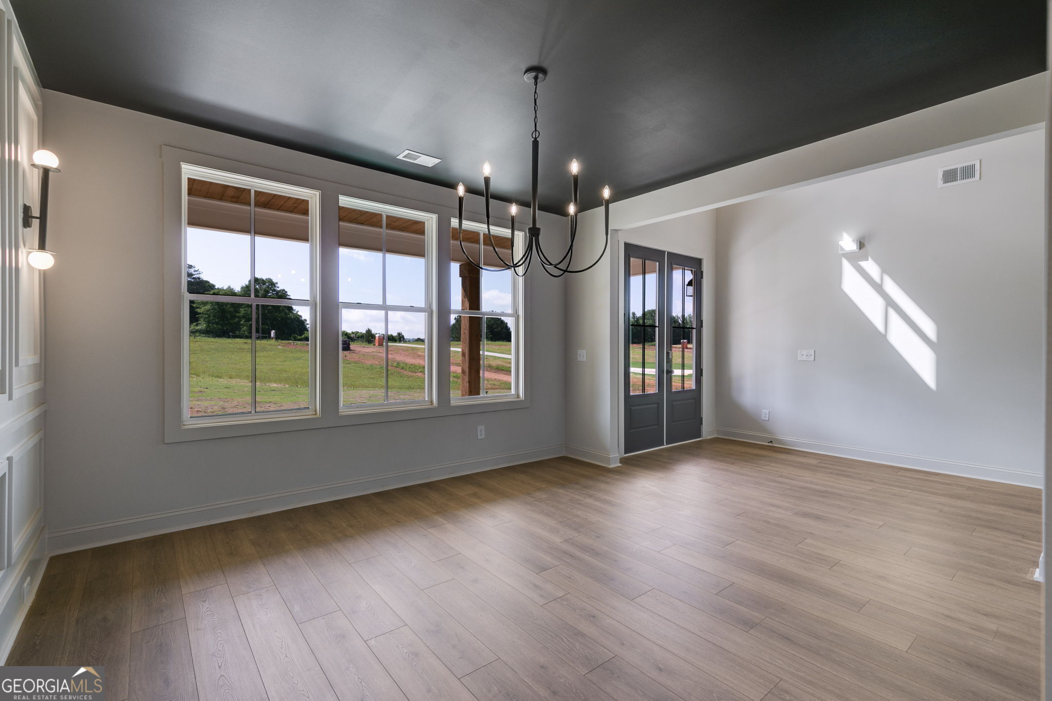 1593 Bethesda Church Road Carrollton, GA 30117 - Photo 9 of 50 a view of an empty room with wooden floor and a window