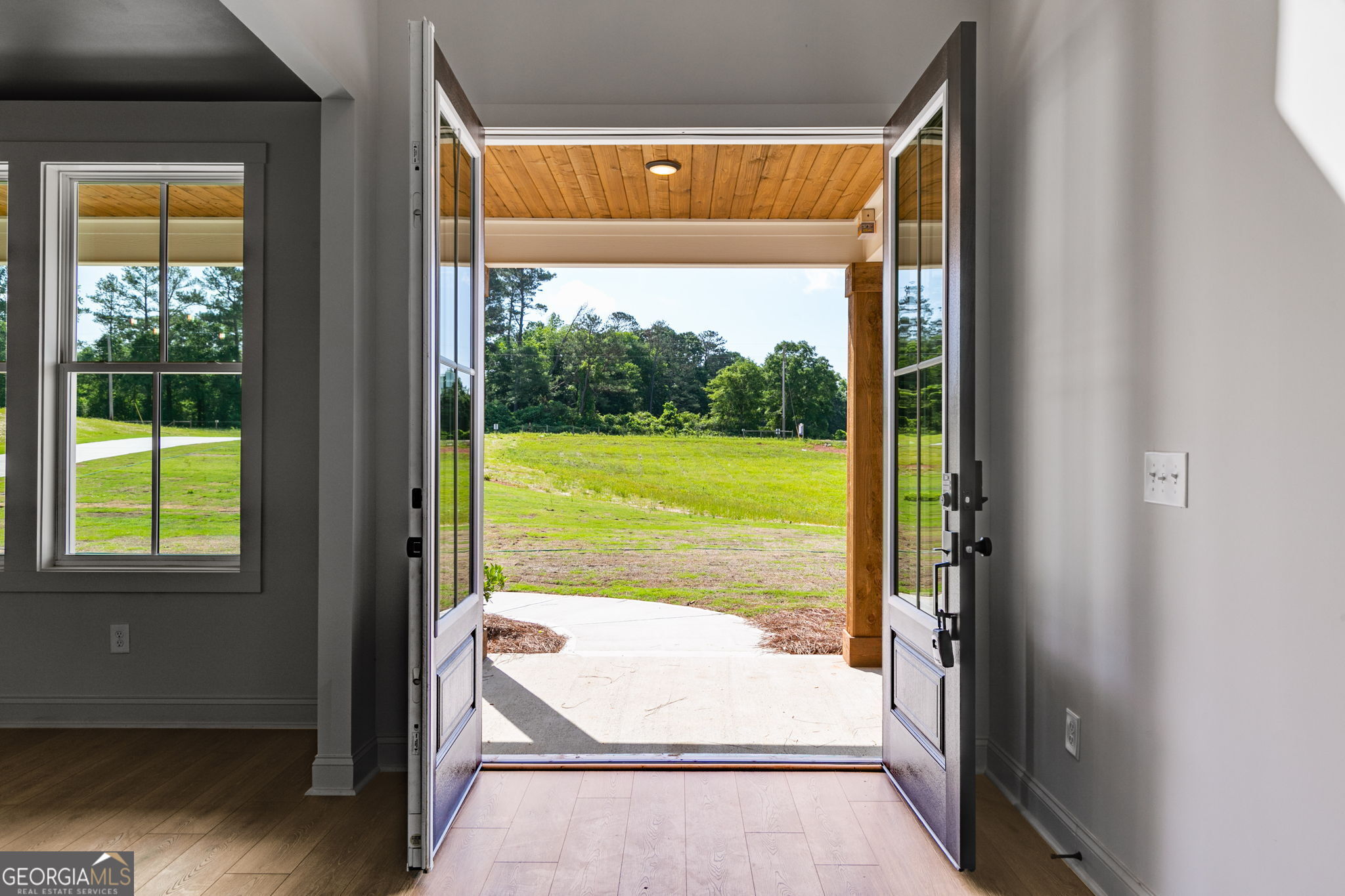 1593 Bethesda Church Road Carrollton, GA 30117 - Photo 10 of 50 a view of a room with a large window and wooden floor