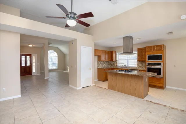 a spacious bedroom with a bed and a large window