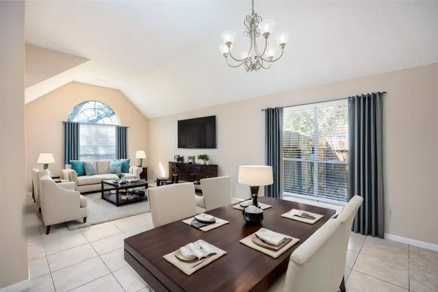 a living room with furniture a large window and a flat screen tv