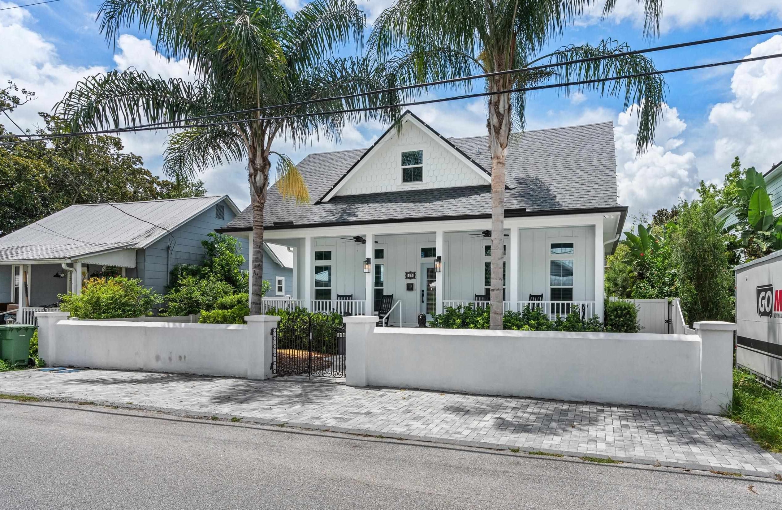 a front view of a house with a garden and yard