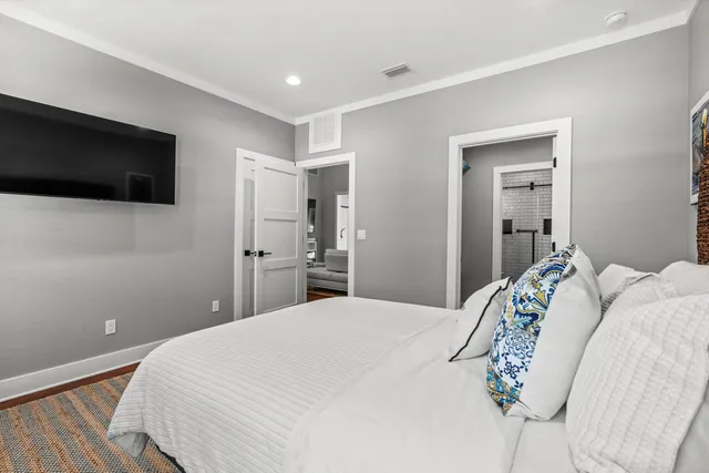 a bedroom with a bed and a television