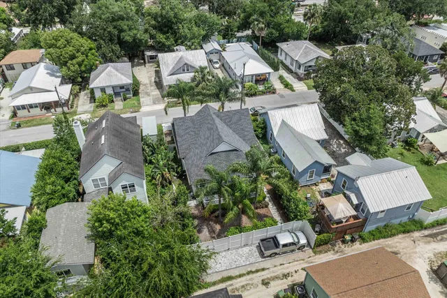 an aerial view of multiple houses with yard