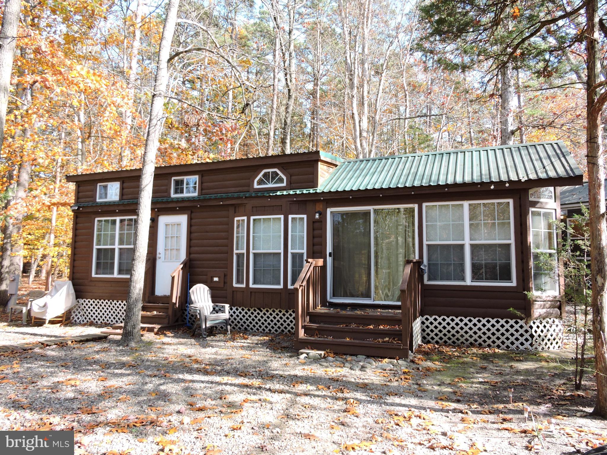a front view of a house with a tree in front