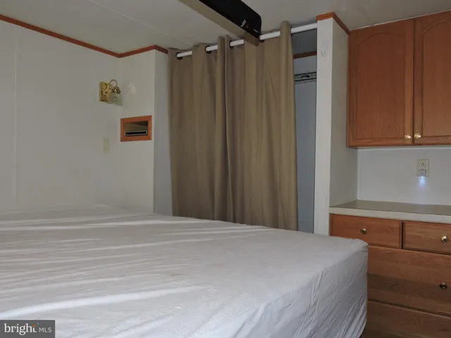 a bedroom with a bed and a mirror