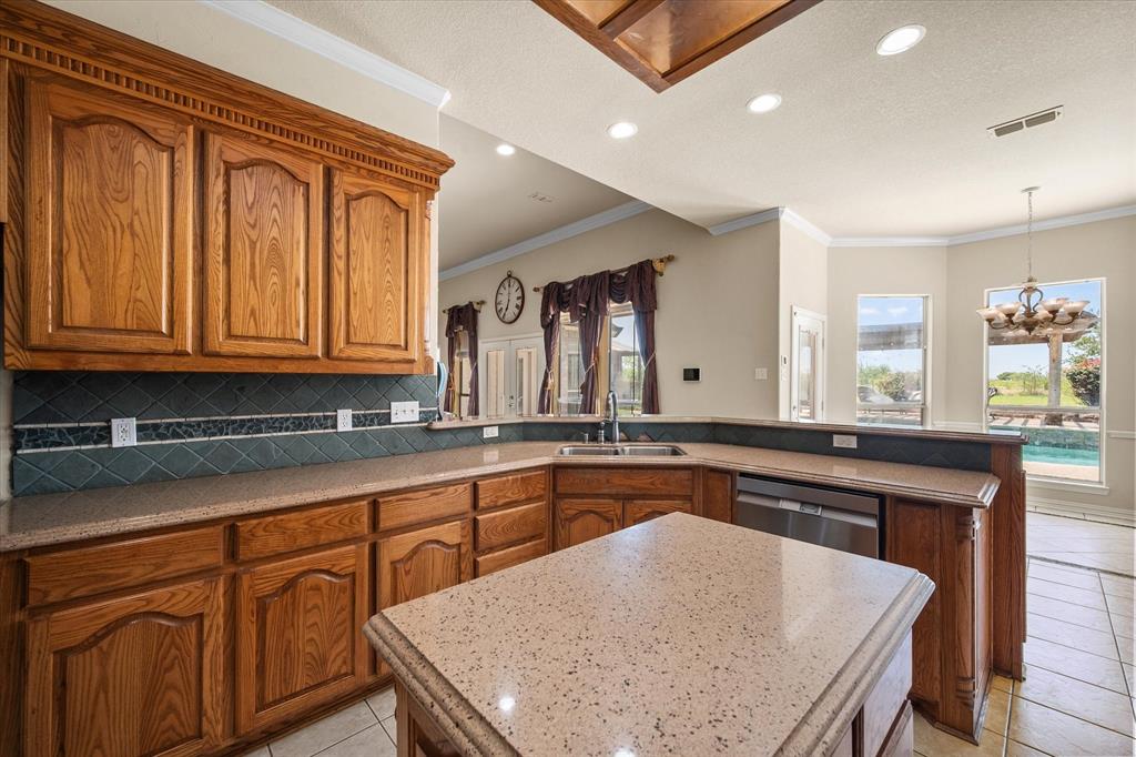 14981 West State Highway Blooming Grove, TX 76626 - Photo 11 of 40 a kitchen with granite countertop sink stove and cabinets