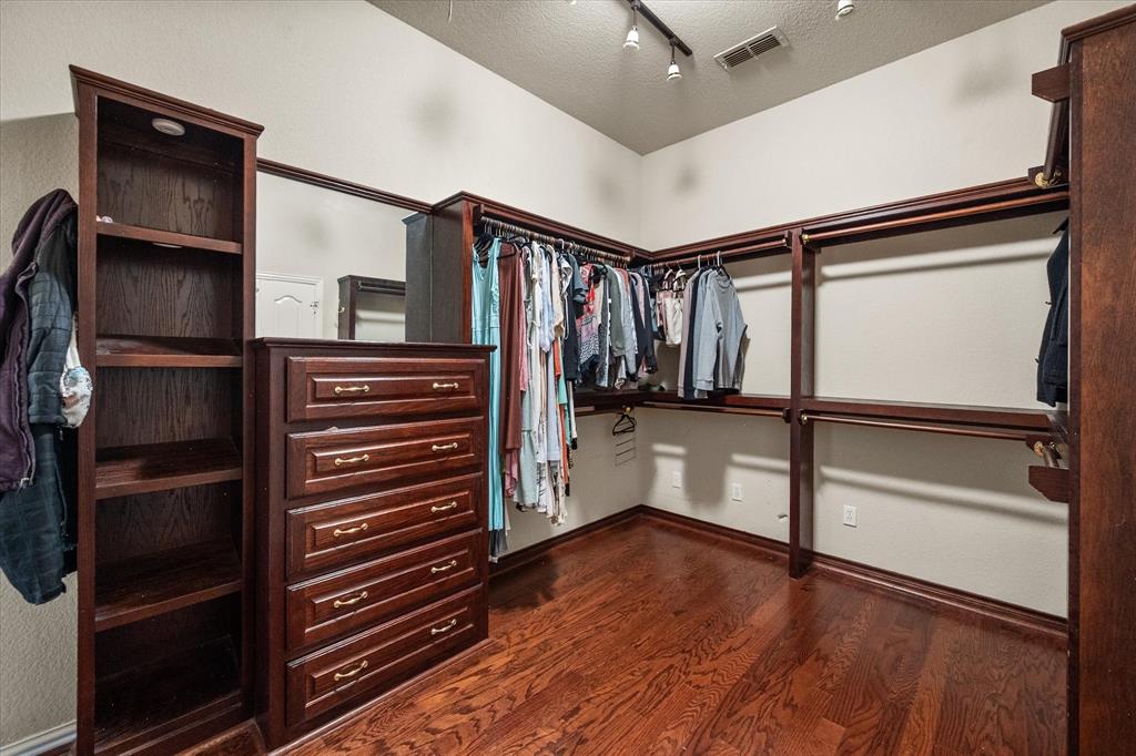 14981 West State Highway Blooming Grove, TX 76626 - Photo 18 of 40 a view of walk in closet with wooden floor and stairs
