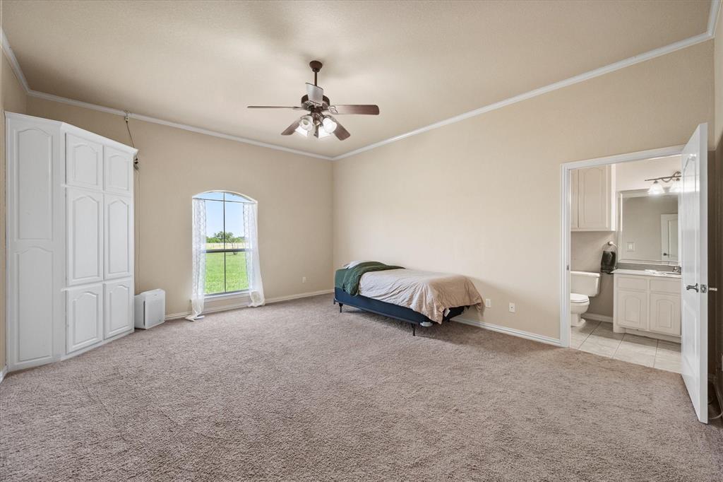 14981 West State Highway Blooming Grove, TX 76626 - Photo 20 of 40 a room with a bed and a chandelier