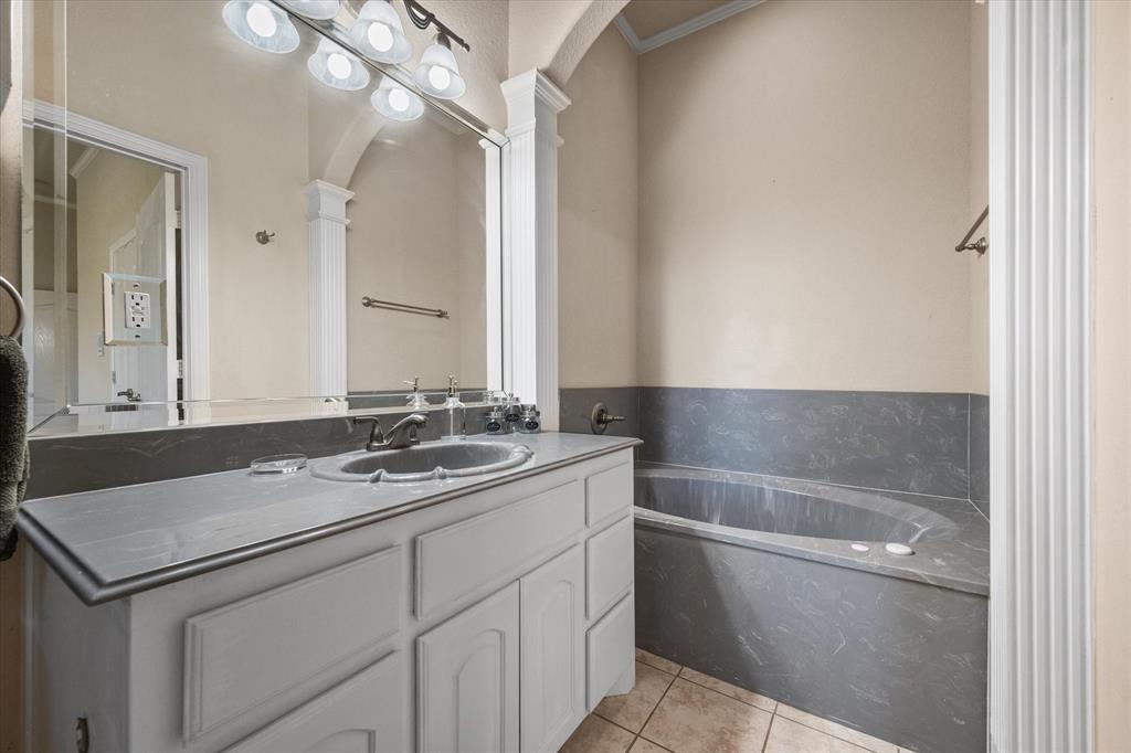 14981 West State Highway Blooming Grove, TX 76626 - Photo 21 of 40 a bathroom with a sink and a bathtub