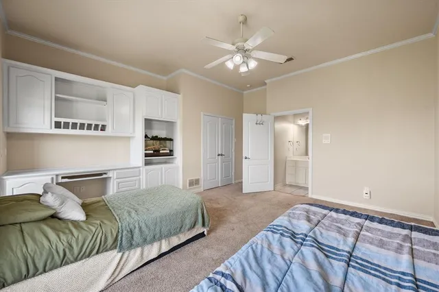 a bedroom with a large bed and chandelier