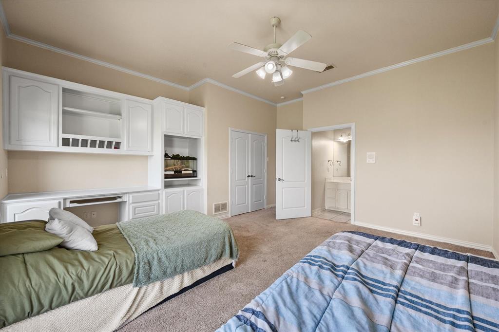 14981 West State Highway Blooming Grove, TX 76626 - Photo 24 of 40 a bedroom with a large bed and chandelier