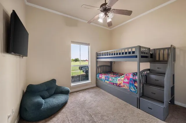 a bedroom with furniture and a flat screen tv