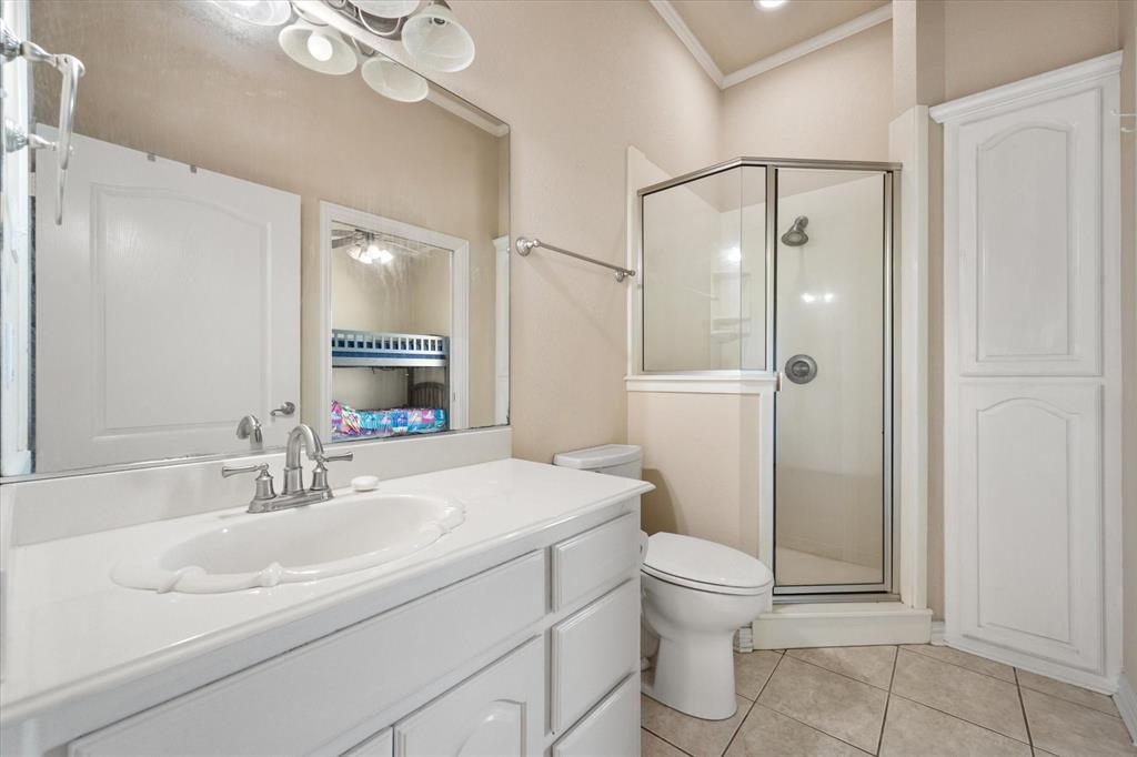 14981 West State Highway Blooming Grove, TX 76626 - Photo 29 of 40 a bathroom with a sink a toilet and shower a mirror