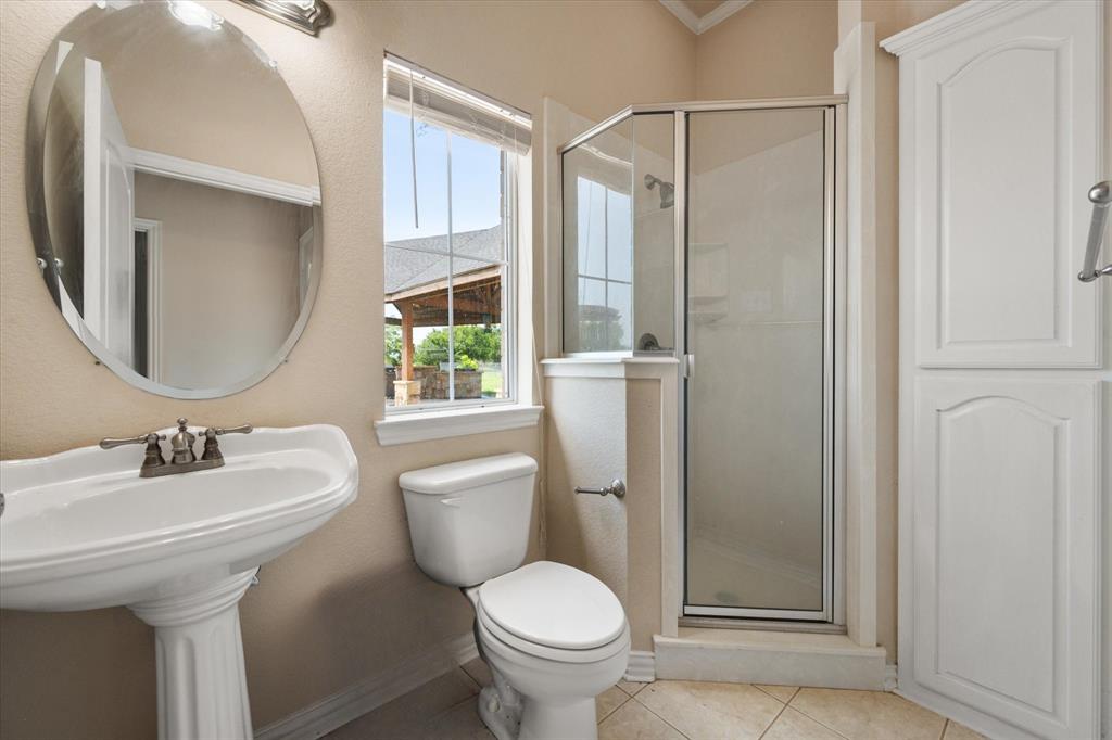 14981 West State Highway Blooming Grove, TX 76626 - Photo 30 of 40 a bathroom with a toilet sink and mirror