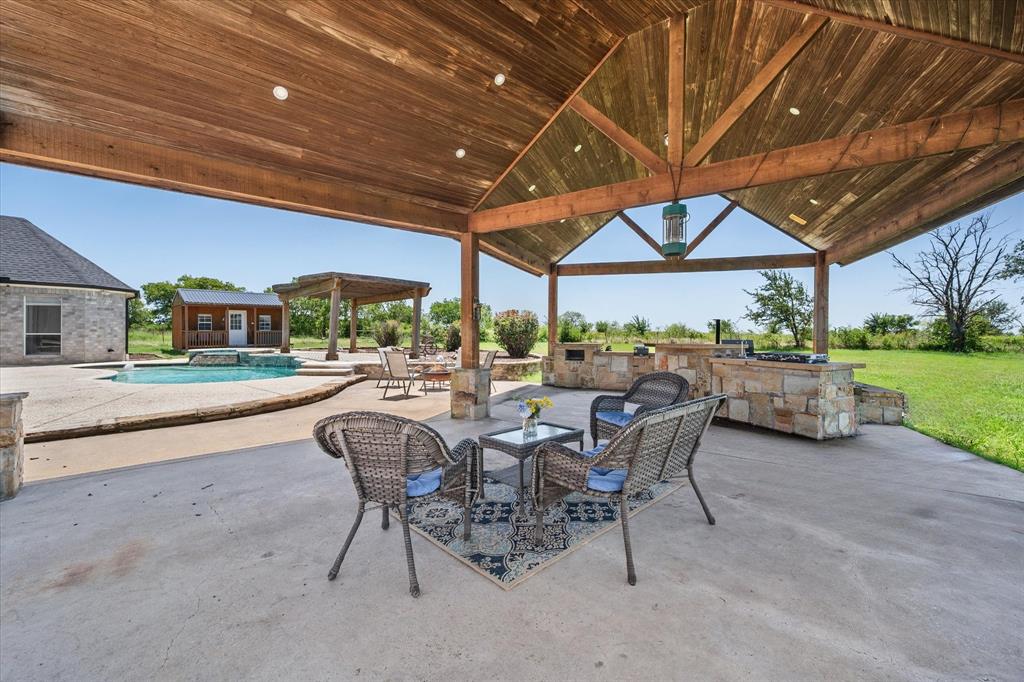 14981 West State Highway Blooming Grove, TX 76626 - Photo 31 of 40 a view of a patio with a table and chairs under an umbrella