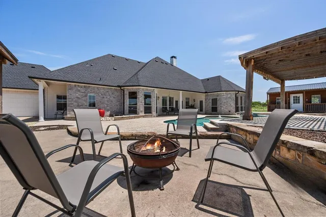 a view of a patio with table and chairs under an umbrella