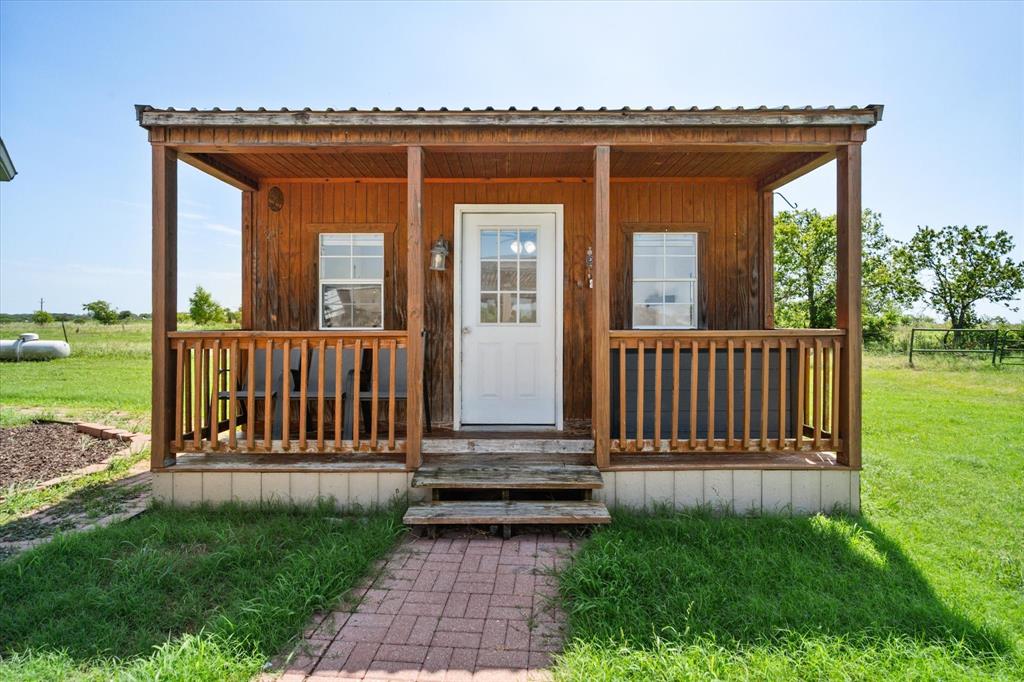 14981 West State Highway Blooming Grove, TX 76626 - Photo 33 of 40 a view of a house with porch and wooden floor