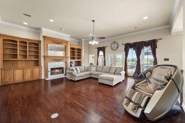 a living room with furniture fireplace and wooden floor