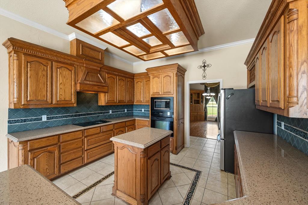 14981 West State Highway Blooming Grove, TX 76626 - Photo 10 of 40 a kitchen with stainless steel appliances granite countertop a sink and cabinets