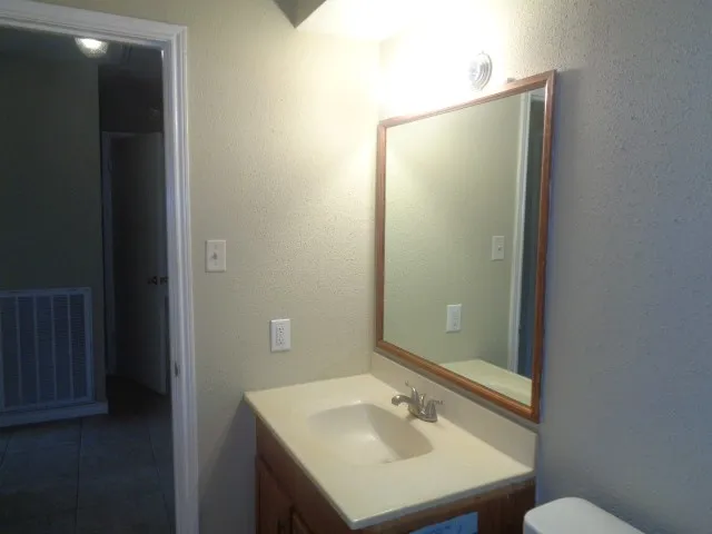 a bathroom with a sink and mirror
