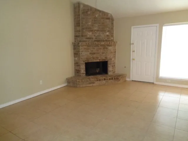 a view of an empty room with a fireplace