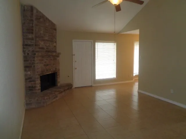 a view of empty room with a fireplace