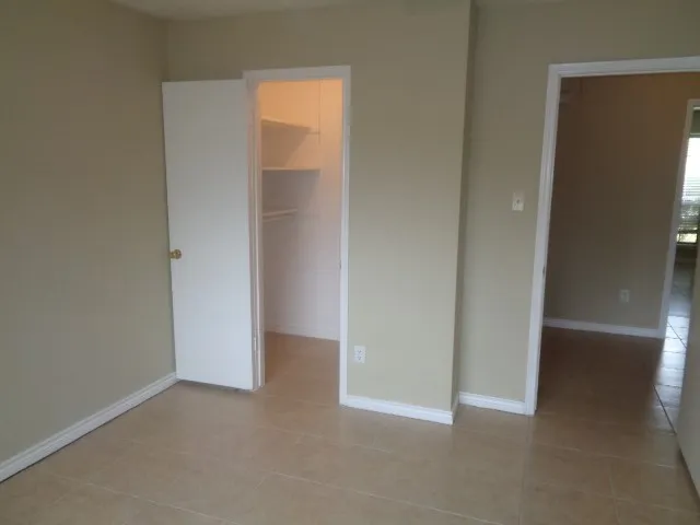 a view of an empty room and closet area