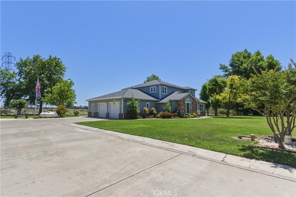 3856 North Gardner Avenue Merced, CA 95340 - Photo 59 of 59 a front view of a house with a yard and garage