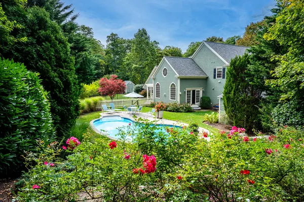 an aerial view of house with yard swimming pool and outdoor seating