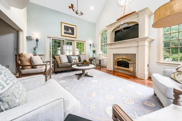 a view of a livingroom with a fireplace and chandelier fan