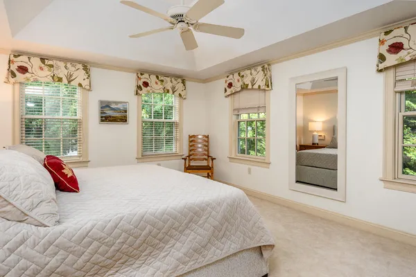 a bedroom with a large bed and a chandelier