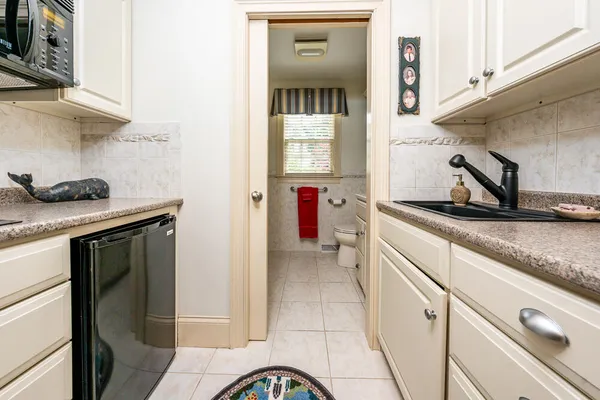 a kitchen with a stove and a white cabinets