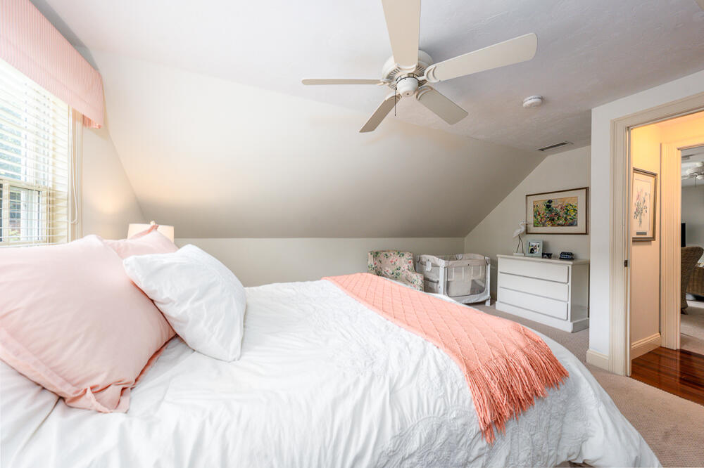 5 Pine Street Sandwich, MA 02563 - Photo 52 of 74 a bedroom with a large bed and a chandelier