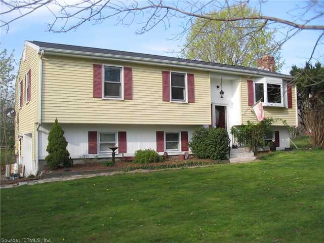 a front view of house with yard and outdoor seating