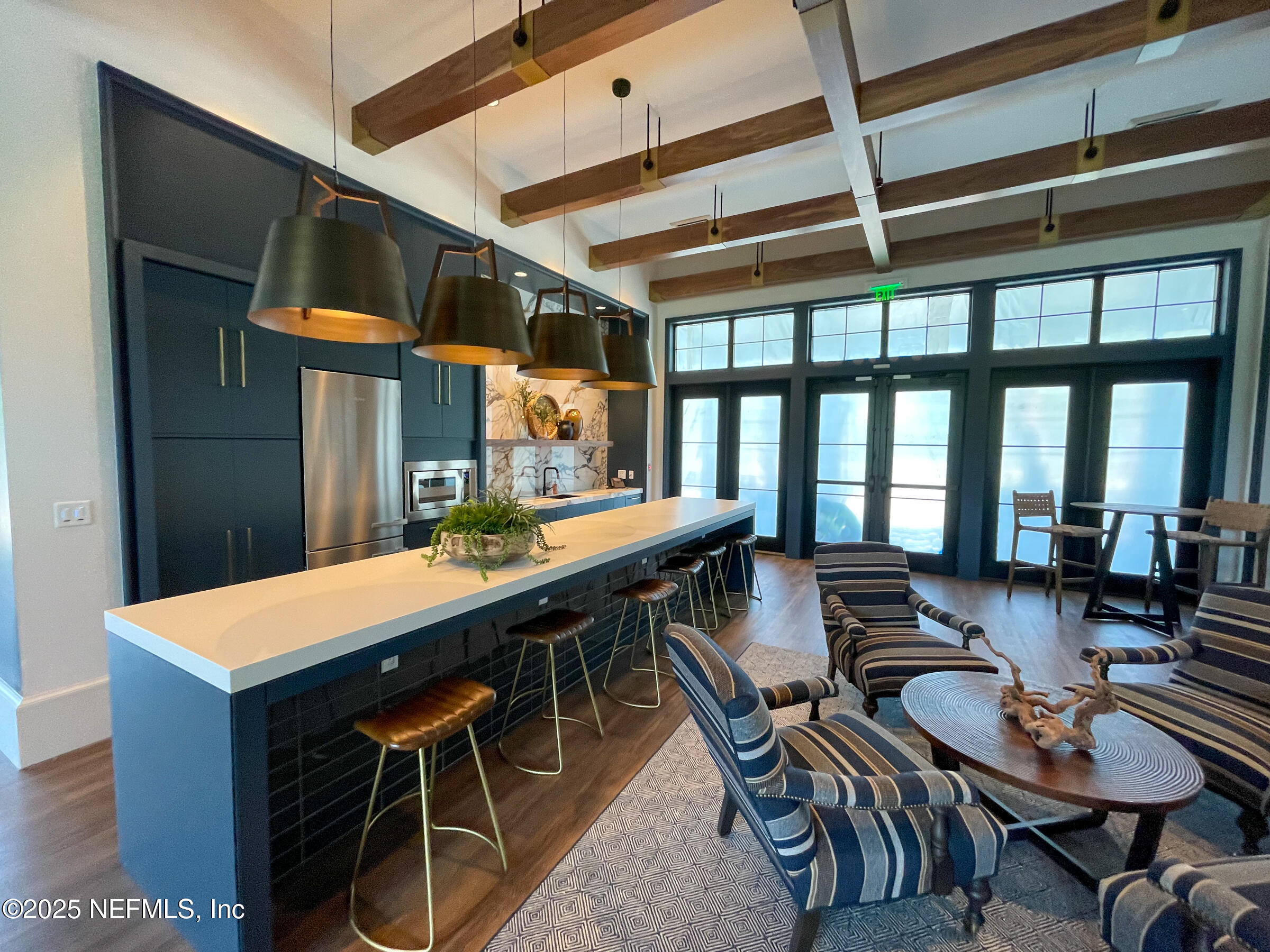 76037 Estuary Way Yulee, FL 32097 - Photo 15 of 42 a room with stainless steel appliances kitchen island granite countertop a dining table and chairs with wooden floor