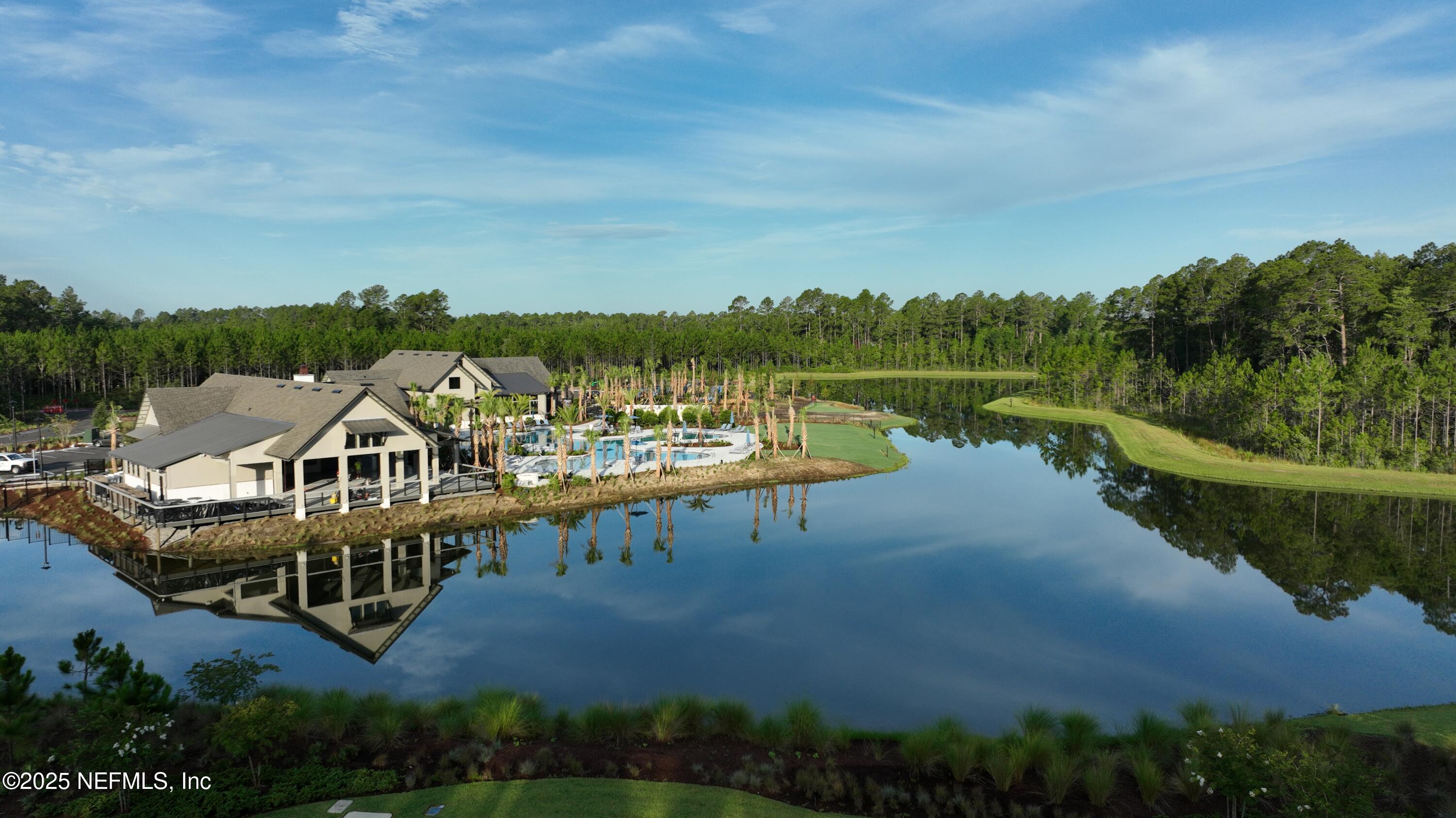 76037 Estuary Way Yulee, FL 32097 - Photo 3 of 42 a view of a lake with a mountain in the background