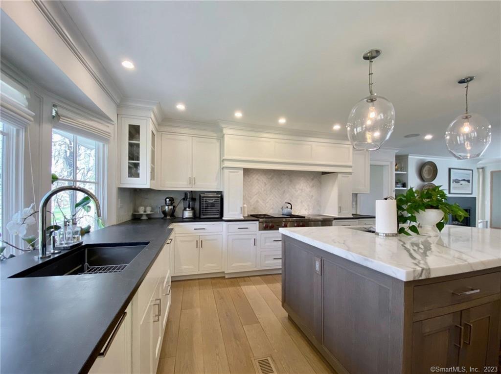 7 Whaling Road Darien, CT 06820 - Photo 8 of 34 a kitchen with counter top space a sink stainless steel appliances and cabinets