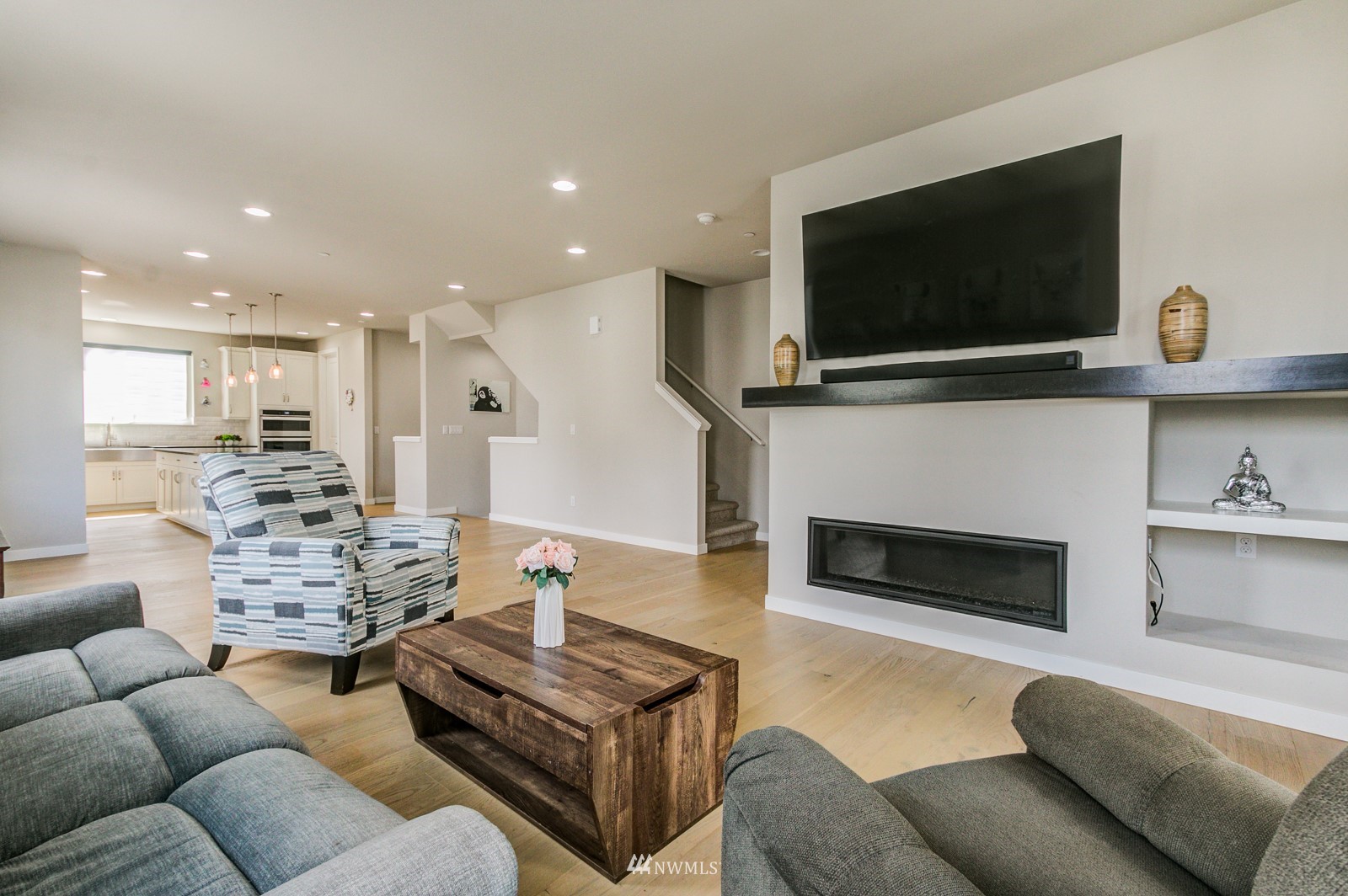 509 237th Place Southeast, Unit E Bothell, WA 98021 - Photo 17 of 35 a living room with furniture a flat screen tv and a fireplace