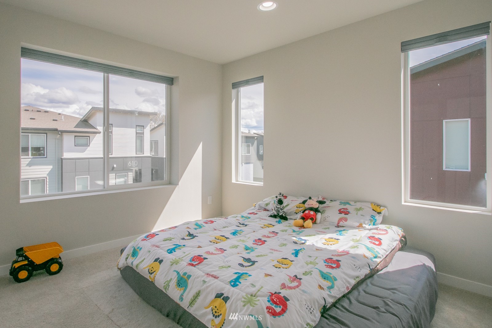 509 237th Place Southeast, Unit E Bothell, WA 98021 - Photo 22 of 35 a bedroom with a bed and a window