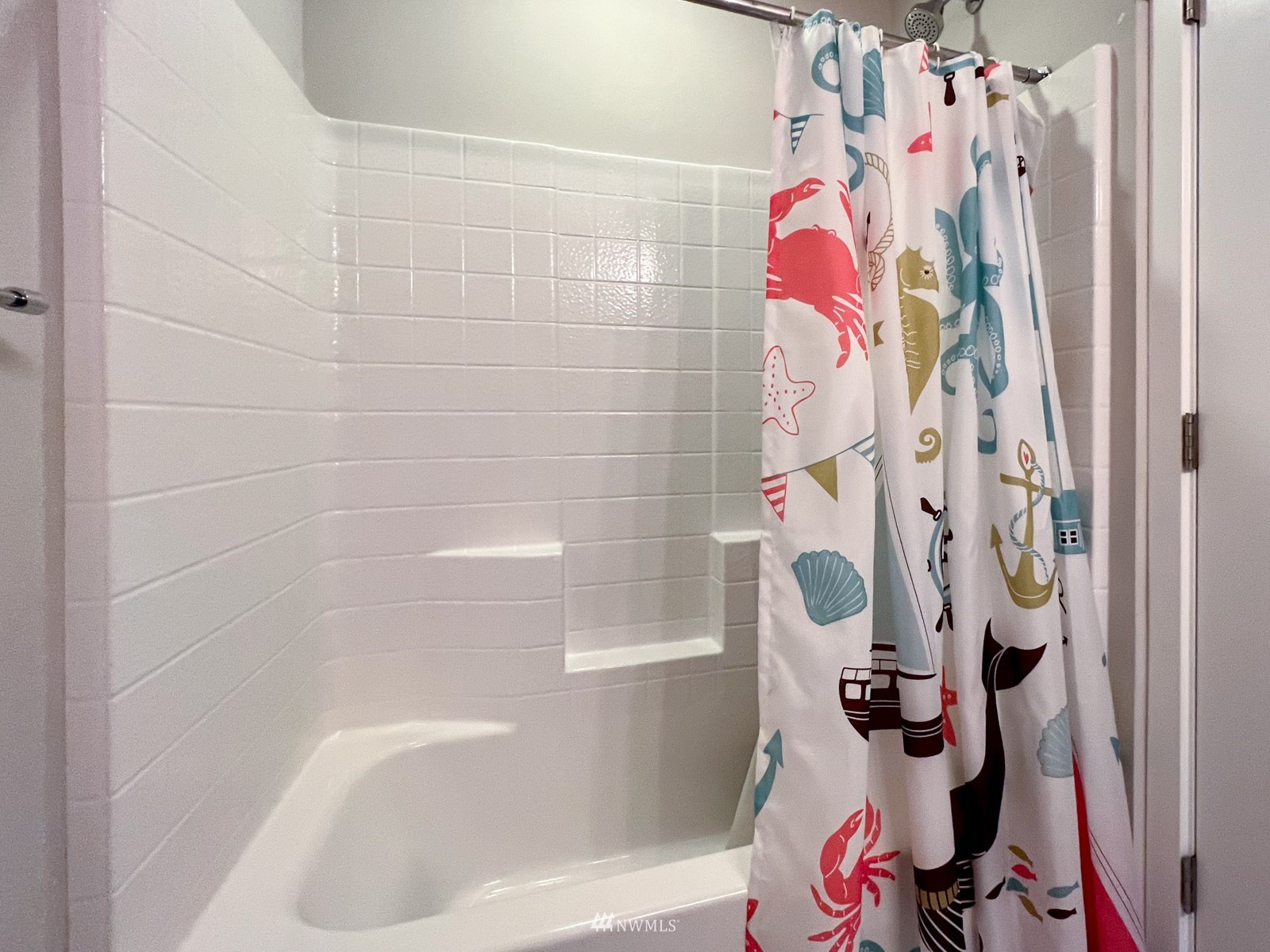 509 237th Place Southeast, Unit E Bothell, WA 98021 - Photo 23 of 35 a bathroom with a bathtub and shower curtain