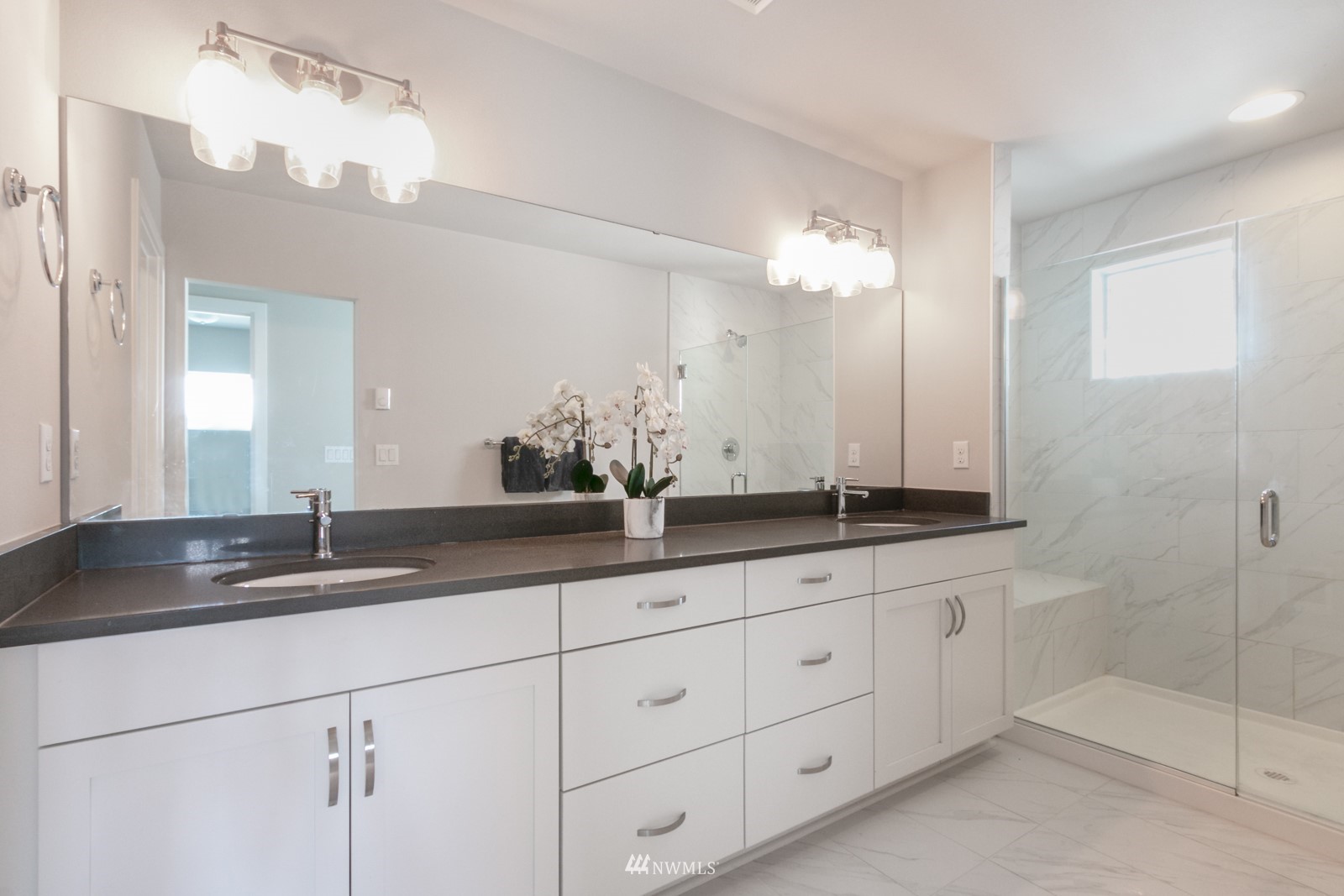 509 237th Place Southeast, Unit E Bothell, WA 98021 - Photo 28 of 35 a bathroom with double sink and a mirror