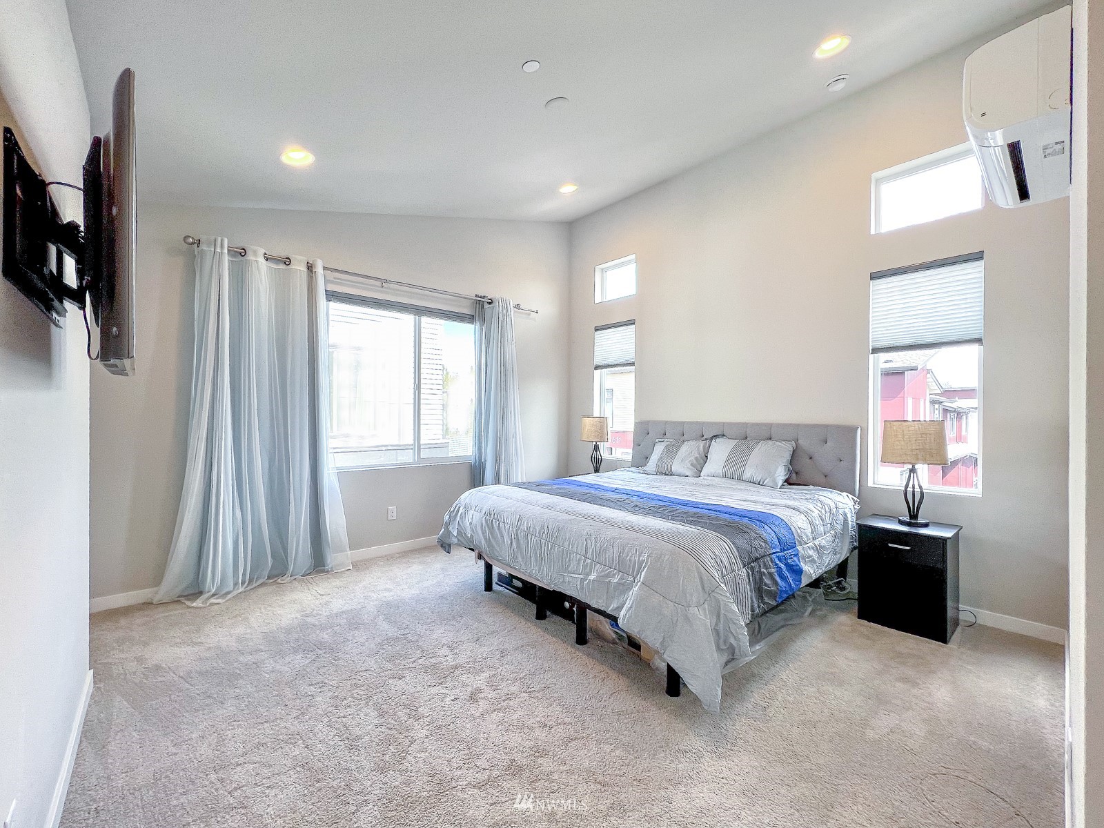 509 237th Place Southeast, Unit E Bothell, WA 98021 - Photo 29 of 35 a spacious bedroom with a bed and a window